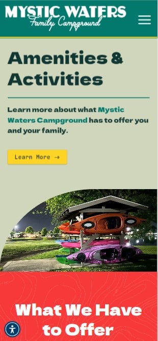 Screenshot of a website for Mystic Waters Family Campground. The header, designed with professional web design, features "Amenities & Activities" in bold text, with a prompt to learn more. Below, there is a photo of colorful kayaks stacked under a shelter. At the bottom, "What We Have to Offer" is displayed.