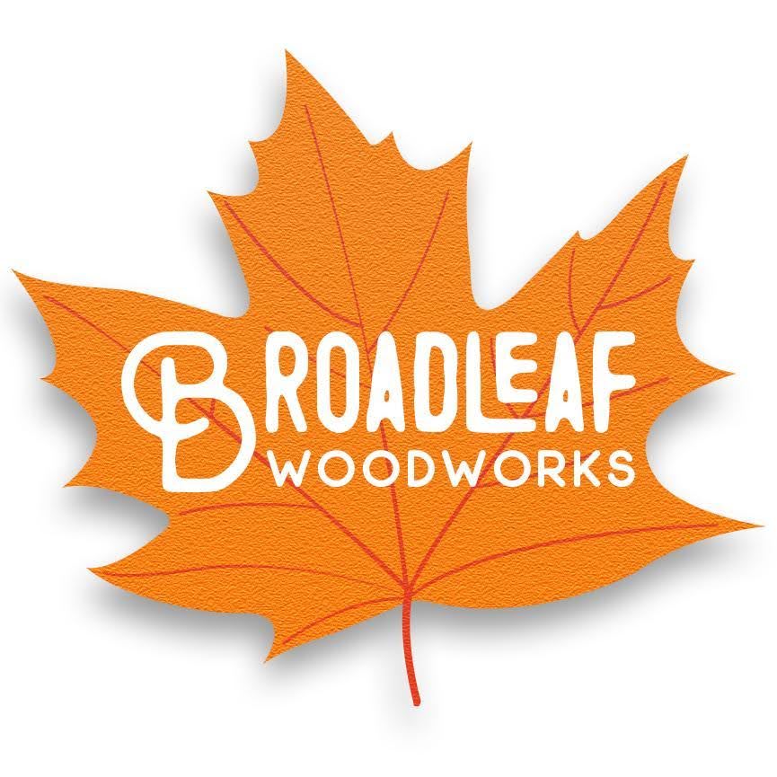 Logo of Broadleaf Woodworks featuring the company’s name in white, stylized text on an orange maple leaf. The "B" in "Broadleaf" is designed to resemble a wooden pattern. Created by Millworks Web Design & Graphics, this logo captures the essence of custom websites and meticulous craftsmanship.