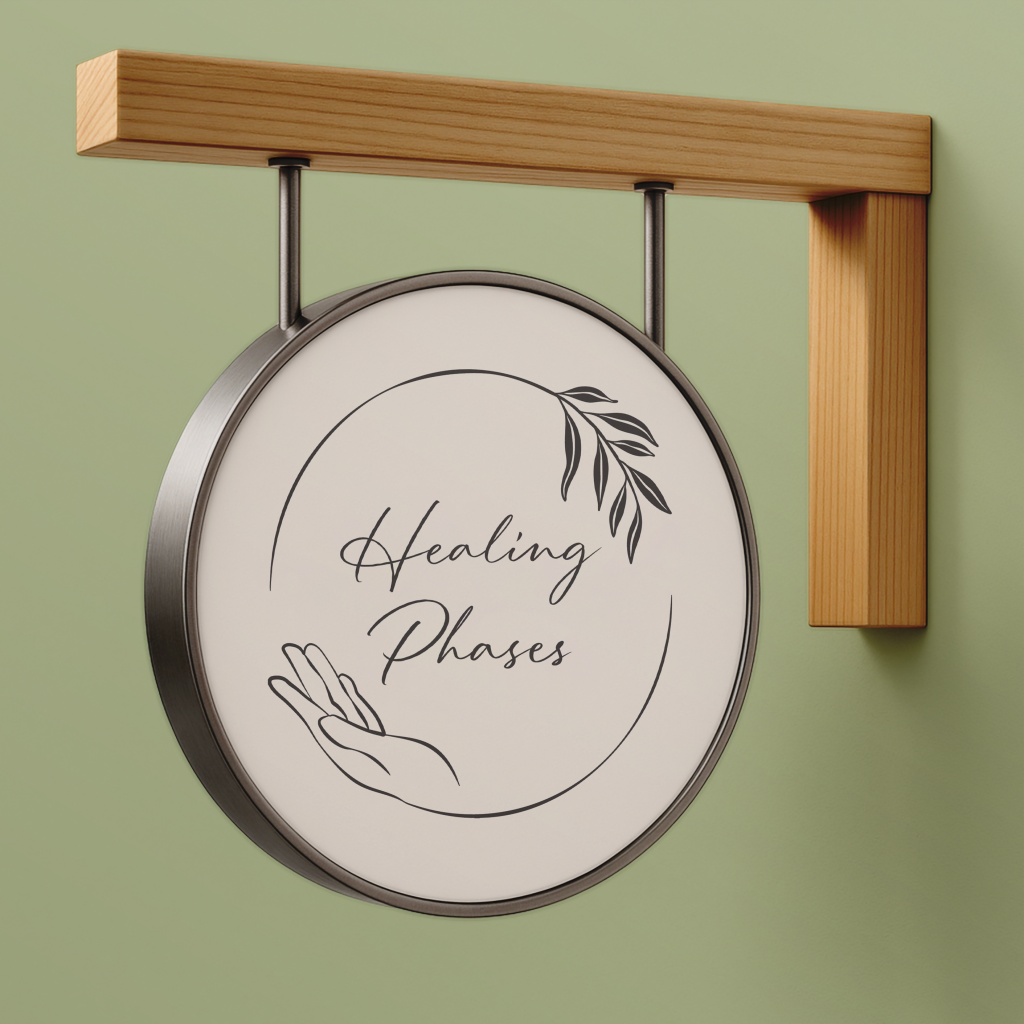 A round hanging sign with a wooden bracket reads “Healing Phases” in script, featuring minimalist line art of a hand and leafy branch on a light background, embodying the gentle theme of healing phases against a soft green wall.