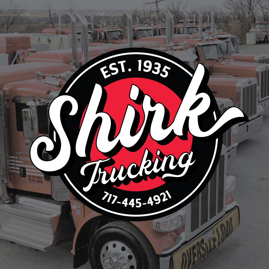 A logo for Shirk Trucking, established in 1935, with their phone number 717-445-4921, is centered over a lot filled with orange Shirk Trucking semi-trucks.