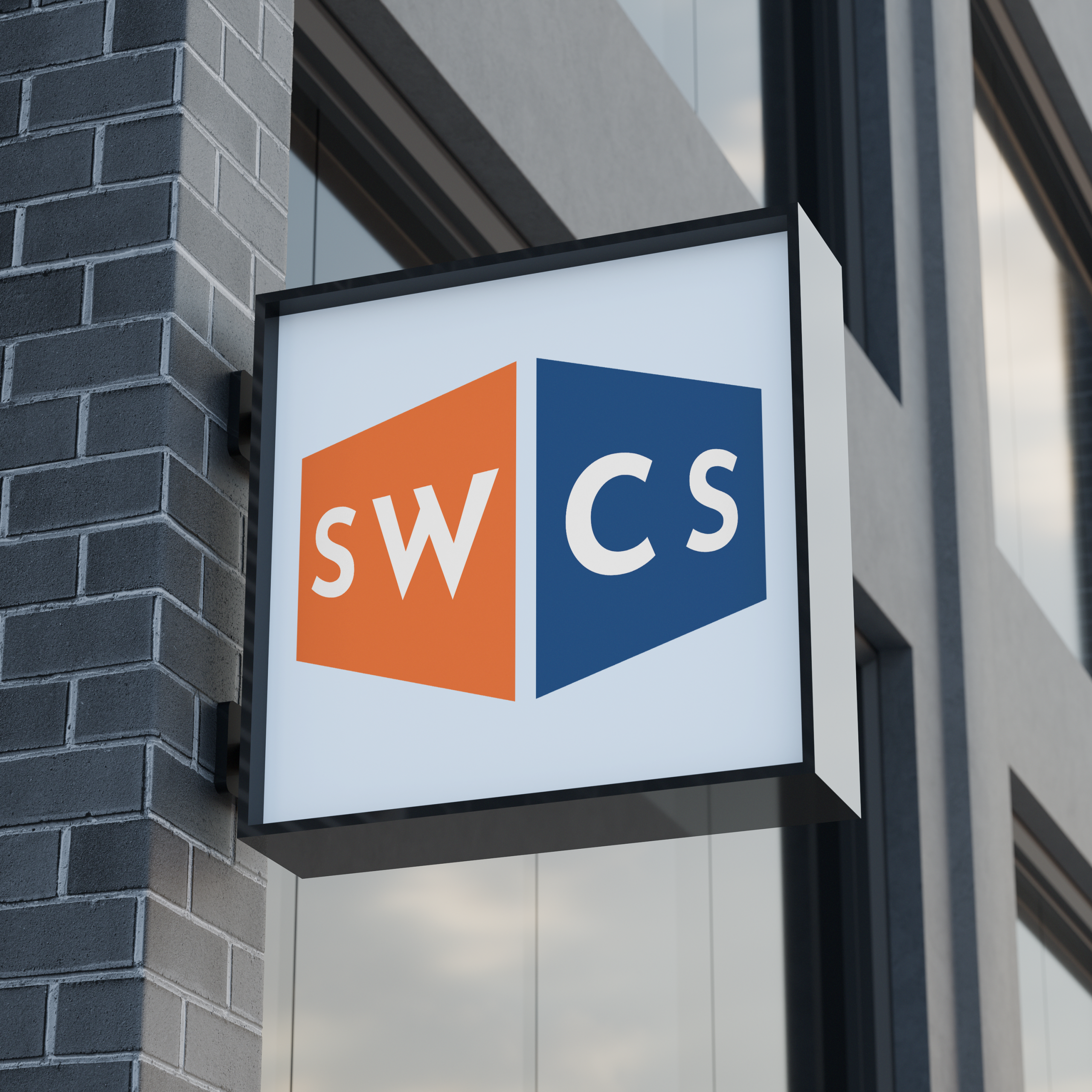 A square sign on a building displays the letters SWCS—SW in white on an orange background and CS in white on a blue background, separated by a diagonal line—signaling the presence of SWCS Insurance.
